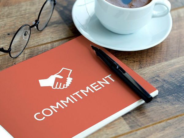 What are the benefits of total commitment, and why is it worthwhile to make the effort?